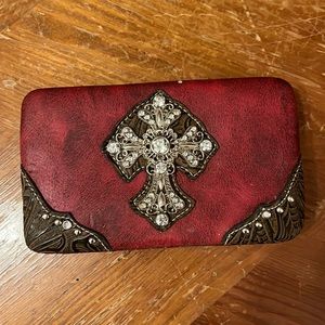 Red with black undertone pattern with faux diamond cross on front.